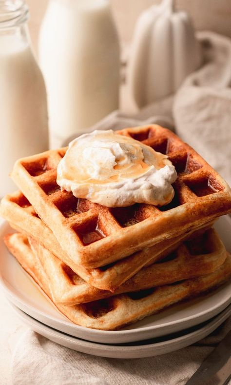 Belgian waffles stacked on a plate and topped with whipped cream and maple syrup. Fall Waffles, Honey Garlic Ribs, Parmesan Crusted Zucchini, Whole Wheat Waffles, Pumpkin Spice Waffles, Spiced Whipped Cream, Cinnamon Waffles, Hero Comic, Waffle Iron Recipes