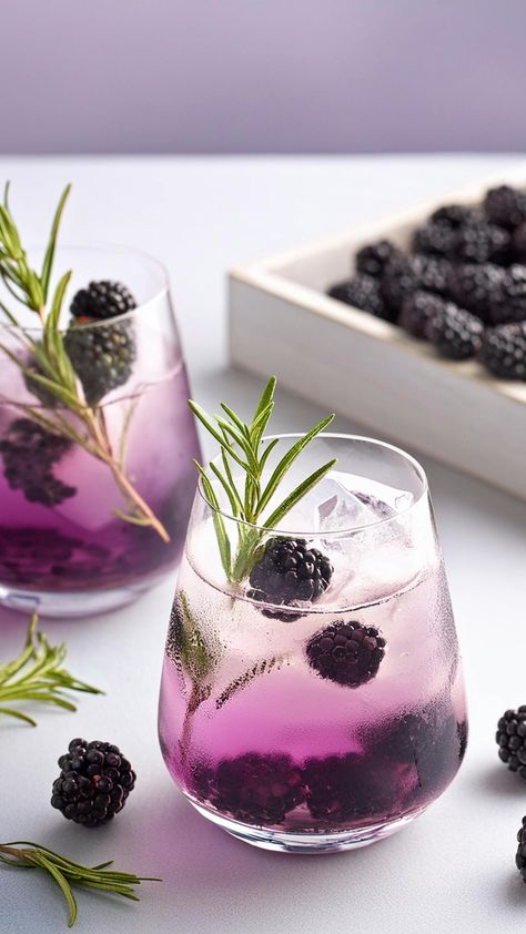 Delight your senses with the vibrant Rosemary Blackberry Bramble, a gin cocktail that combines the sweetness of blackberries with the aromatic notes of rosemary syrup. This refreshing drink is perfect for a summer evening or any special occasion. Bramble Gin Cocktail, Gin Rosemary Cocktail, Blackberry Gin Cocktail, Blackberry Drink, Witch Cafe, Gin Cocktails Summer, Bramble Recipe, Blackberry Cocktail, Gin Drink Recipes