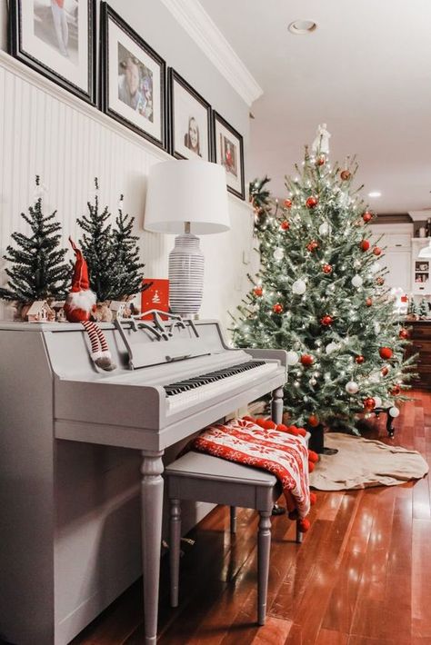 a vintage grey piano with some Christmas trees, a gnome, a grey bench with a printed red blanket, a Christmas tree with red and white ornaments Grey Christmas Decor, Piano Christmas, Painted Pianos, Piano Decor, Christmas Piano, Exterior Furniture, Grey Christmas, Upright Piano, Christmas Interiors