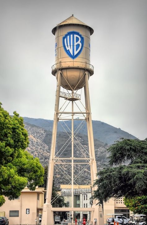 The Warner Bros. Water Tower is a historic water tower located at the Warner Bros. lot in Burbank. Built in 1927, it stands 133 feet tall. The tank has a capacity of 100,000 gallons but it now serves as a company icon. Warner Brothers Logo, Animaniacs Characters, Galaxy Planets, Warner Bros Studios, Movie Studios, Los Angeles Travel, Warner Brothers, Water Tower, About Time Movie