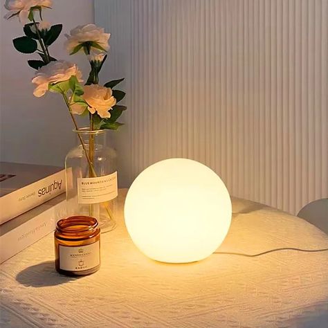 This is the simple charm of the Futura's Studio Bubble Lamp, designed to create a serene atmosphere in any corner of your home.   Features:    🌐 Perfectly round, opal glass design  🔆 Provides a warm, ambient glow  🎨 Minimalist style  🛠️ Durable construction  🌱 Energy-efficient lighting    Why You'll Love It:    🌟 Offers a gentle and inviting light  🏡 Ideal for bedside tables, quiet reading nooks, or as a gentle night light  🎁 Perfect gift for lovers of minimalist and functional designs   Elevate your décor with the pure and peaceful light of Futura's Studio Bubble Lamp. Ball Table Lamp, Bubble Lamp, Home Simple, Reading Nooks, Bubble Lamps, Home Office Lighting, Night Night, Energy Efficient Lighting, Lamp Led