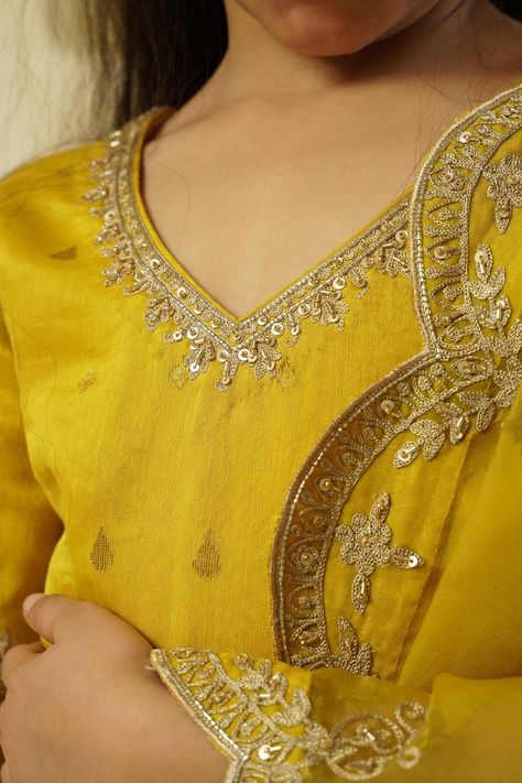 Lime yellow lehenga skirt featuring drop pattern highlighted with lace and aari embroidered borders. Comes with matching aari embroidered blouse and scalloped hem embroidered dupatta. Components: 3 Pattern: Embroidered Type Of Work: Aari Neckline: V-neck Sleeve Type: Half Fabric: Chanderi Handloom: 50% Silk X 50% Cotton, Lining: Shantoon Color: Yellow Other Details:  Blouse back closure Lehenga side tasselled drawstring Back cut-out neck with tassels Attached lining Note: Outfit worn by boy chil V Neck Kurti Design, Embellished Lehenga, Yellow Kurti, Yellow Lehenga, Lime Yellow, Embroidery On Kurtis, Scalloped Border, Kurti Embroidery Design, Drops Patterns