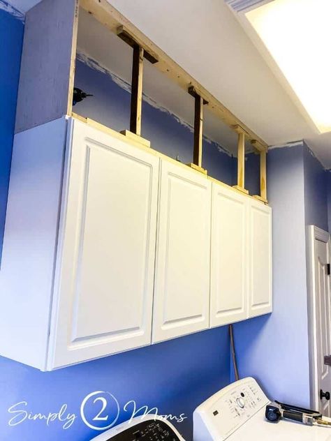 Tired of the ugly, dust-collecting space above cabinets? Learn how to easily extend your cabinets to the ceiling with wood and molding. Get step by step instructions to close up the gap over your cabinets in your kitchen or laundry room. Give your builder grade cabinets a custom look with this simple DIY project! Extending Cupboards To Ceiling, Boxes On Top Of Kitchen Cabinets, Adding Boxes To Top Of Cabinets, Box On Top Of Cabinets, Upper Cabinets To Ceiling Diy, Adding A Cabinet To Kitchen, Raise Kitchen Cabinets To Ceiling Add Shelf, Close Space Above Kitchen Cabinets, Filling In Space Above Kitchen Cabinets