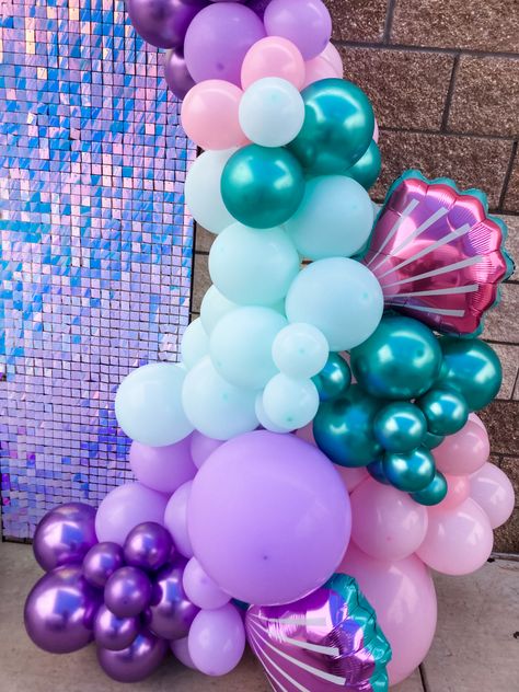 Balloon arch. Pink. Purple. Teal. Silver. Party backdrop. Mermaid party. Under the sea. Sea shell balloons. West Texas parties Teal And Pink Balloon Garland, Pink Purple Teal Balloon Garland, Pink Purple And Teal Birthday Party, Purple Pool Party, Silver Party Backdrop, Under The Sea Balloon Arch, Mermaid Balloon Arch, Balloon Arch Pink, Homecoming 2023