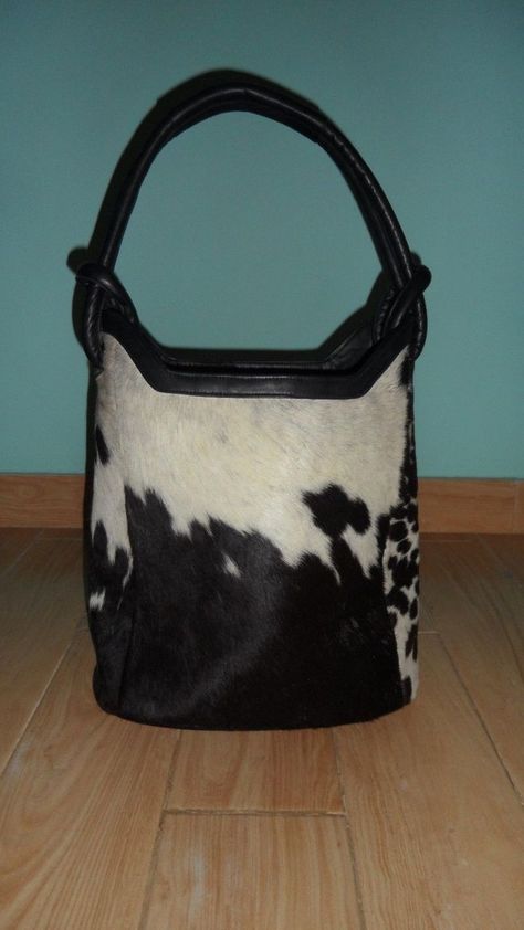 Our Brown And White Cowhide Tote Bag  is casual sophistication at it's best! Luxurious inside and out made of supple  leather and premium hair on hide. You will look and feel great carrying this functional piece of art.   This is a unique and classy hair on cowhide bag all in one. It is made with exquisite craftsmanship and will last for years to come. Let us warn you! You will receive many stops and compliments carrying this handbag. Go ahead and treat yourself! You will NOT be disappointed. Bucket Bag Style, Classy Hair, Purse Style, Cowhide Purse, Western Cross, Cowhide Handbags, Bucket Purse, Cowhide Bag, Fur Bag