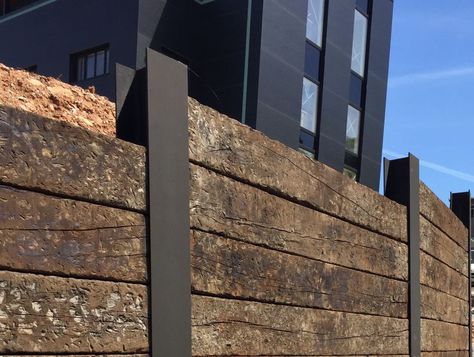 Wall of Used oak Railway sleepers slotted into RSJs Backyard Retaining Wall, Railroad Ties Landscaping, Railroad Tie Retaining Wall, Sleeper Wall, Sleeper Retaining Wall, Sleepers In Garden, Wood Retaining Wall, Diy Retaining Wall, Railroad Tie