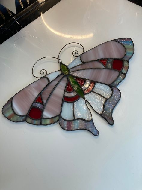 "stained glass window hanging Butterfly moth Art Deco In Pink and red Usa Handcrafted. This handcrafted butterfly moth suncatcher was created using pink milky glass, red textured and red iridescent glass, multicolored art glass, white opal glass, and green glass with silver iridescent coating for its body, wire work antenna made of brass with line attached for hanging. Finished off with an antique patina for a lovely contrast. polished to a high gloss finish. measures aprox. 8\" inches tall x 11.5\" inches wide USPS shipping fully insured  I take great pride in all my works, everything is handcrafted with only top quality materials for a beautiful work of art that with proper care can last a lifetime. not mass produced, this is unique in that no two works are exactly alike." Hanging Butterfly, Diy Stained Glass Window, Stained Glass Candles, Stained Glass Patterns Free, Moth Art, Fused Glass Artwork, Glass Window Art, Stained Glass Birds, Stained Glass Ornaments