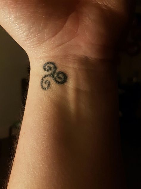 small 20p size celtic symbol left wrist 3 swirls meaning power of 3 ( religious) also celtic scottish/irish decent Celtic Swirl Tattoo, Irish Symbol Tattoos, Irish Tattoos For Women, Ireland Tattoos, Irish Gaelic Tattoo, Small Irish Tattoos, Gaelic Tattoo, Celtic Tattoo For Women, Celtic Symbols And Meanings