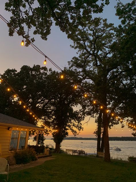 Beautiful lake sunset with string lights Porch View Aesthetic, Old Lakehouse Aesthetic, Latkes Aesthetic, Lakeside House Aesthetic, Houses By The Lake, Lake House Life Aesthetic, Outside Life Aesthetic, House On A Lake Aesthetic, Cottagecore Lake House