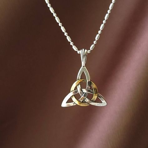 "Celtic Triangle Knot in solid 925 sterling silver with 24 gold plate. Has the phrase, \"Circle of Life\" inscribed on the flip-side of the pendant.  Celtic Knot in a triangular formation is also called the Trinity Knot, and Triquetra.  The points on the triangle symbolize the three natural elements, earth, air, and water. The connected swirls symbolize the eternal circle of life.  In the Christian religion, the Triquetra  symbolizes the Holy Trinity.  This symbol is often used in engagement and Triquetra Jewelry, Celtic Triangle, Lovers Knot, Celtic Knot Jewelry, Elements Earth, Trinity Knot, Irish Jewelry, Symbolic Jewelry, Triangle Pendant