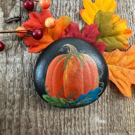 This little, fall pumpkin is hand painted on a rock collected from the shore of Lake Ontario. Each stone is treated with a clear sealer to protect the paint. It's bright colors and gold accents make it a perfect fall addition for any home!  Each rock is sold individually. Painted Rocks For Fall, Thanksgiving Painted Rocks, Fall Painted Rocks, Fall Rocks, Fall Addition, Rock Painting Flowers, Fall Rock, Hand Painted Pumpkin, Painted Pumpkin