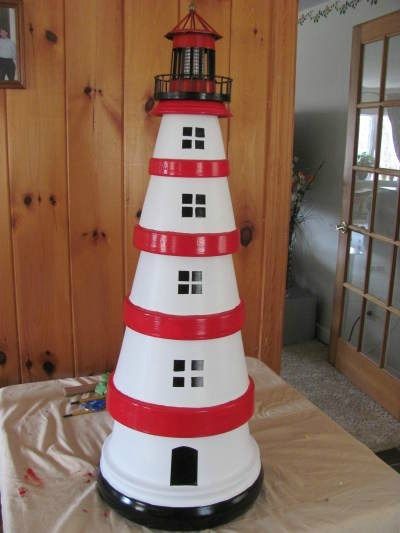 This is a guide about making a terra cotta lighthouse. An inexpensive craft project made with clay pots is a lighthouse for a garden decoration. How To Make A Lighthouse From Clay Pots, Terra Cotta Pot Lighthouse Diy, Plant Pot Lighthouse, Light House Project For School, Lighthouse Diy How To Make, Clay Pot Lighthouse With Solar Light, Terracotta Lighthouse, Diy Lighthouse, Clay Pot Lighthouse