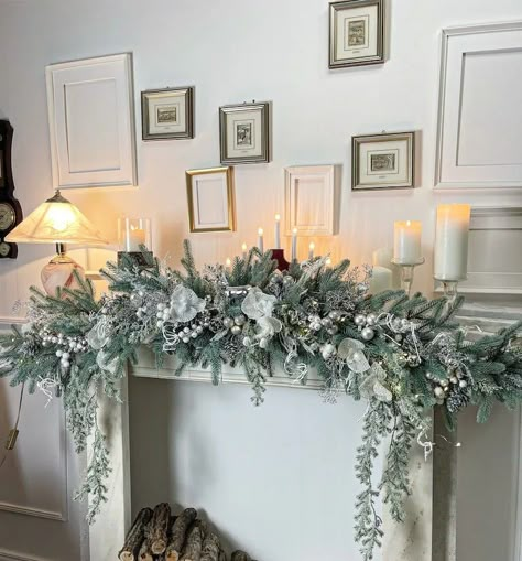 Victorian Christmas Fireplace Decorations, Christmas Mantle Swag Garlands, White Garland Christmas Decor, Christmas Mantelpiece Ideas, Mantle Decorations For Christmas, Xmas Mantle Decorations, White Fireplace Christmas Decor, Garland On Mantle Christmas, Flocked Garland Mantle