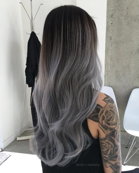 The Mermaid hair trend might have people trading in their conventionally-colored locks for bright, ocean-inspired hues, but there’s another unique style that’s quickly gaining momentum: gray ombré hair. Wearers of this trend have the crowns of their heads dyed dark gray, and it gradually fades in tone as the color nears the ends of their mane. This form of hair art is a take on the Granny-style trend, in which people dyed their hair an all-over artificial gray. Ombré takes it a step further ... Grey Balayage, Grey Ombre Hair, Brunette Balayage, Silver Hair Color, Caramel Highlights, Grey Hair Color, Ombre Hair Color, Grunge Hair, Hair Colours