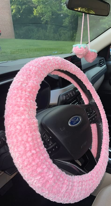 This is a Handmade Crochet Car Set. It has two seat belt covers, a mirror hanging strawberry and a steering wheel cover. The material is so soft and comfy. It is super cute and very appealing to the eye. Knitted Car Accessories, Crochet Sterling Wheel Cover, Steering Wheel Crochet Cover, Coquette Car Decor, Crochet Car Wheel Cover, Car Crochet Accessories, Crochet Seat Cover, Crochet Car Decor, Crochet Car Accessories