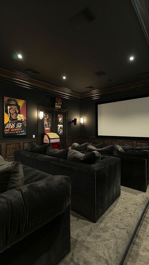 Dark-toned luxury home theater with plush sofas, large screen, ambient lighting, and movie posters for a cinematic experience. Industrial Theater Room, Home Movie Room Ideas, Movie Room Ideas Small Home Theaters, Cinema Room Ideas, Home Theater Snack Bar, Cinema Living Room, Basement Theater Room, Basement Theater Room Ideas, Cinema Room Decor