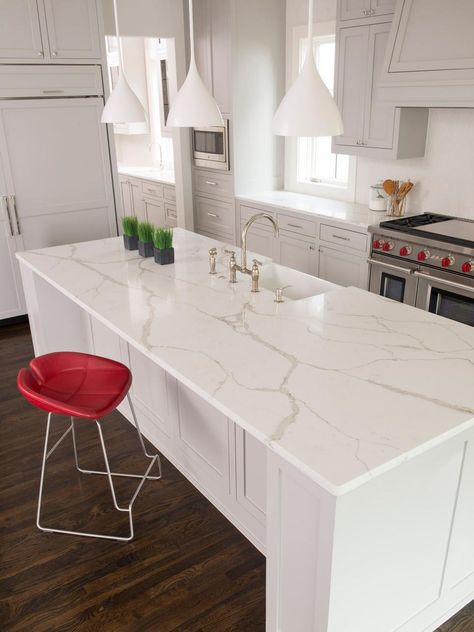 White Quartz Island Countertop In Transitional Kitchen With White Pendants and Bright Red Accents Borghini Quartz Countertops, Kitchen Counter Hanging Lights, Calacatta Extra Quartz, White Quartz With Gray Veining And White Cabinets, Gray Outdoor Kitchen, Valor White Quartz Countertops, Bright White Quartz Countertop, Calacatta Borghini Quartz, Calacatta Quartz Kitchen