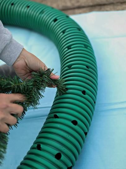 How to Make an Oversized Christmas Wreath | HGTV Christmas Wreath Designs, Outdoor Christmas Wreaths, Large Christmas Wreath, Hgtv Shows, Drainage Pipe, Easter Eggs Diy, Faux Greenery, Christmas Decorations Diy Outdoor, Front Porch Christmas Decor