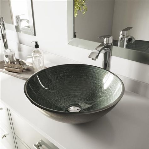 This bathroom sink by Vigo® will completely transform your bathroom into a modern oasis. Includes a faucet with matching pop-up drain and mounting ring.Polished glass interior with textured exteriorSolid Tempered GlassScratch-resistant interior glassFaucet in Chrome finish constructed of solid brassIncludes solid brass pop-up drain and mounting ring in matching finishLimited Lifetime Warranty | Vigo VIGO Glass Vessel Sink and Faucet - Chrome VGT839 Vigo | Glass Vessel Sink And Faucet - Chrome | Silver Faucet, Bathroom Sink Bowls, Brushed Nickel Faucet, Silver Bathroom, Round Sink, Modern Bathroom Sink, Glass Vessel Sinks, Vessel Faucets, Bathroom Sink Drain