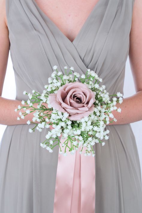 This brides’ bouquet is elegant, romantic, and perfect if you have chosen mauve as one of the accent colors in your wedding. This radiant bouquet is comprised of babies’ breath and a trio of mauve roses. Shining mauve ribbon cascades from this bouquet, adding a chic final touch. This bouquet is a lovely option for those who would like to order their bouquets well before their wedding date, in order to ensure that they are the exact design you had in mind. As usual, our bouquets are expertly craf Small Blush Bouquet, Bridesmaids Bouquets Simple, Wedding Bouquets Bride Simple, Rustic Chic Bouquet, Simple Bridesmaid Bouquets, Maid Of Honor Bouquet, Single Rose Bouquet, Small Bridesmaid Bouquets, Mauve Roses