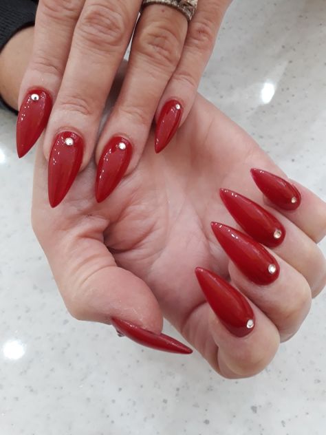 Red pointed nails with diamonds Red Nails Jewels, Red And Diamond Nails, Nails Red With Diamonds, Red Almond Nails With Rhinestones, Red Nails With Rhinestones Simple, Red Nails With Jewels, Red Acrylic Nails With Gems, Red Acrylic Nails Designs Rhinestones, Red Jewel Nails