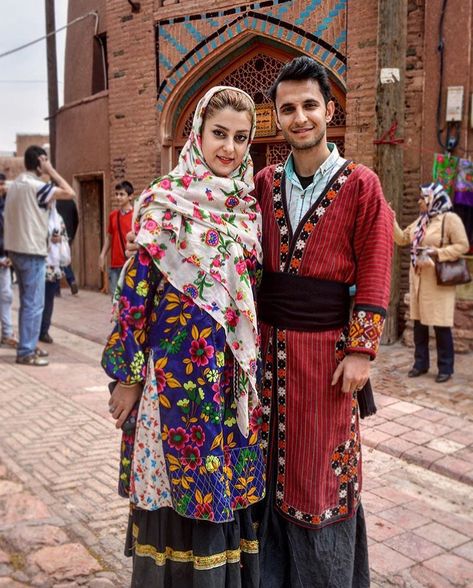 A Persian couple wearing traditional dress of Abyaneh village, in Isfahan. You can choose our village tour to touch the pure Iranian culture still alive in villages. https://www.irandestination.com/tour/iran-villages-tour/  #Iranvillage  #Irantravelagent #Irandestination #Irantravelagency #Irantourpackages #Persiantravelagency #Irantravel #traveltoIran   #coupletravel #halaltravel #Iran #traditionaldress #abyaneh #redvillage Iran Outfit, Iran Clothes, Traditional Iranian Clothing, Iran Clothing, Iranian Clothes, Persian Dress, Persian Princess, Persian People, Persian Women