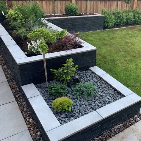 Black Slate Landscaping, Black Rendered Garden Walls, Modern Front Garden Ideas Uk, Black Garden Wall, Outdoor Gardens Design Front Yards, Small Outdoor Fireplace Ideas, Planters In Front Of House, New Build Garden Ideas, Face Mosaic