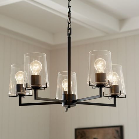 With a dramatic black finish and clear glass shades, the Birk 5 light chandelier is the perfect blend of elegance and charm. Offering a cozy and welcoming ambiance, it can serve as an eye-catching centerpiece in a dining room, foyer, bedroom, or stairway Kichler Birk 5-Light Black Farmhouse Led; Dry rated Chandelier | 82411 Lowes Dining Room Light, How To Pair Kitchen And Dining Lights, Living Room Modern Chandelier, Dining Room Lighting Black, Dining Room Lighting Over Round Table, Light Over Kitchen Table, Modern Farmhouse Dining Room Lighting, Kitchen Lights Over Island, Table Lighting Ideas