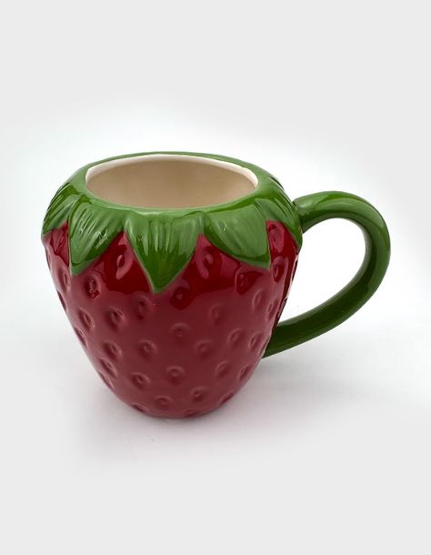 Strawberry Mug. Crafted With Care, This Ceramic Mug Mimics The Iconic Shape Of A Juicy Strawberry, Bringing A Touch Of Sweetness To Your Cup Of Coffee Or Tea. 15.2 X 10.9 X 10.7cm. 100% Ceramic. Dishwasher Safe, Microwave Safe. Imported. Strawberry Mug Pottery, Strawberry Ceramic Mug, Face Mugs Ceramic, Cool Ceramic Mugs, Hand Made Mug, Cool Mugs Ceramics, Ceramic Cup Ideas, Silly Mugs, Ceramic Mug Ideas