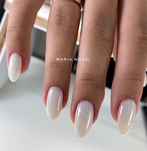 Nails White And Sparkle, Neutral Nail With Glitter, White Glittery Almond Nails, Bachelorette Nails The Bride White, Nails White With Glitter, Milky White Sparkly Nails, Sparkly White Acrylic Nails, White Nails Gold Glitter, Nye Nails Almond Shape