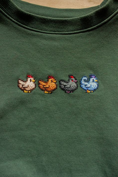 Cross Stitch Shirt Design, Cross Stitch On Shirt, Cross Stitching On Clothes, Cross Stitch On Tshirt, Cross Stitch T Shirt, Stardew Valley Knitting, Pixel Art Embroidery, Cross Stitch Sweatshirt, Silly Cross Stitch