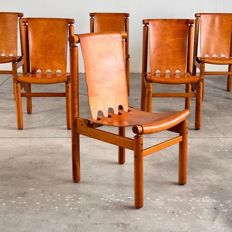 Step into the timeless elegance of mid-century Italian craftsmanship with this impeccable set of six Ilmari Tapiovaara dining chairs, meticulously crafted by La Permanente Cantù circa 1950. Each chair is a testament to the marriage of form and function, boasting a sleek wooden structure that exudes sophistication and durability. The warm hues of the cognac leather upholstery effortlessly complement the rich tones of the wooden frame, creating an inviting ambiance that beckons guests to linger at the dining table. Whether adorning a contemporary dining space or adding a touch of vintage charm to a traditional setting, this exquisite set promises to elevate any interior with its timeless allure and unparalleled craftsmanship. Indulge in the allure of mid-century sophistication and make a sta Caramel Leather Dining Chairs, Restaurant Furniture Design Chairs, Furniture Trends 2024, Dining Table Leather Chairs, Fancy Farmhouse Decor, Kitchen Chairs Modern, Desert Glam, Downtown House, Furniture Photography