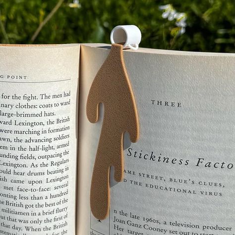 PRICES MAY VARY. ✔ Charming and Unique Design: The Spilled Coffee Bookmark features a cute and humorous design of spilled coffee on a page corner, adding a touch of whimsy to your reading routine. It's a conversation starter and a fun accessory for any book lover. ✔ High-Quality Materials: Crafted with durable materials, this bookmark is built to last through many reading sessions. The high-quality construction ensures that it securely holds your place in any book without adding bulk or weight. Book Reading Accessories, Book Lovers Crafts, Cute Bookmark Ideas, Bookmark Design Ideas, 3d Bookmarks, Library Fundraiser, Coffee Bookmark, Bookmark Unique, Wallet Inspiration