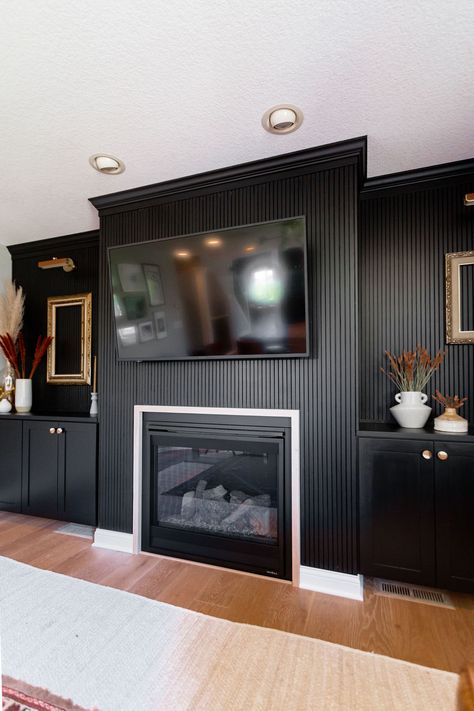 Black Accent Wall With Fireplace And Tv, Black Fluted Fireplace, Wood Slat Fireplace Wall With Mantle, Mantle Black Fireplace, Wood Panel Fireplace Wall, Wood Panel Fireplace, Black Living Room Walls, Black Modern Fireplace, Dark Fireplace Wall