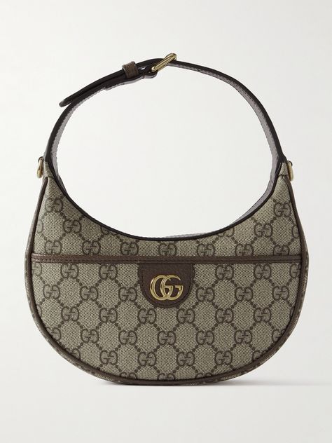 Gucci's accessories are nothing short of impeccable. This 'Ophidia' shoulder bag has been crafted in Italy from coated-canvas in a crescent shape, trimmed with a leather strap and centered with the iconic 'GG' hardware. Store your lip balm and compact as well as cardholder in the pocket. Gucci Iconic Bag, Gucci Saddle Bag, Mini Shoulder Bag Outfit, Gucci Bag Ophidia, Brown Gucci Bag, Gucci Ophidia Bag, Y2k Bags, Shoulder Bag Outfit, Gucci Clothing