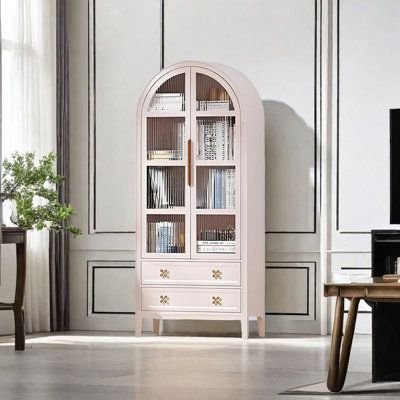 The main frame of the bookcase is made of solid wood, which provides solid support for the bookcase with its natural texture, excellent load-bearing performance and stable structural characteristics Lineyinmer Color: Pink | Lineyinmer French vintage arched glass door bookcase brownWood in Pink | 68.9" H X 29.53" W X 13.78" D | Wayfair Glass Door Bookcase, Door Bookcase, Bookcase With Glass Doors, Dream Apartment, Natural Texture, Glass Door, French Vintage, Elegant Design, Bookcase