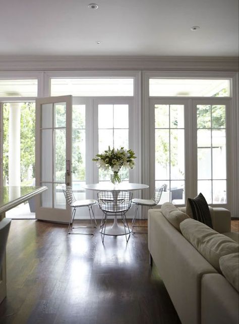 Suzie: HGTV - Wall of French doors & transom windows, Marble Saarinen Dining Table and Bertoia ... Glass Door Living Room, Large Front Doors, French Doors With Transom, Saarinen Dining Table, Door Living Room, French Doors Patio, Transom Windows, Contemporary Dining Room, Living Room Windows