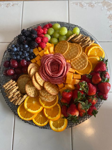 Charcuterie board surrounded with grapes, circular orange slices, blueberries, blackberries, strawberries, raspberries, mild cheddar cheese cubes, a different variety of crackers  and a salami rose. All on a circular platter. Salami Cheese Fruit Platter, Cute Easy Charcuterie Board, Fruit Cheese Cracker Platter, Cheese Salami Platter, Cracker Cheese Board, Chacudory Board, Charcoochie Board Ideas, Fruit And Cracker Charcuterie Board, Cachutery Board Ideas Small