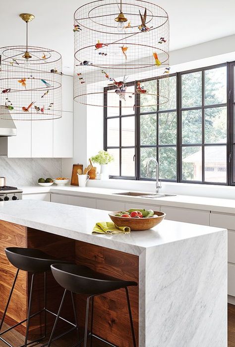 In this kitchen, cage-like pendants get an added touch of whimsey with the addition of faux birds. The see-through mesh also doesn’t block the views outside, where the real birds hang out. | Photographer: Valerie Wilcox | Designer: Stephanie Pellatt, Pivot Design Group; Leanne Tammaro & Adolphina Karachok, Designtheory Narrow Kitchen Island, Whimsical Kitchen, Walnut Kitchen, Pantry Wall, Narrow Kitchen, Walnut Cabinets, Kitchen Remodel Design, White Oak Floors, White Quartz Countertop