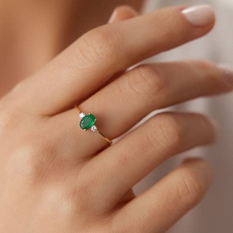 This stunning ring features a round emerald surrounded by diamonds in a halo setting. The ring is made of 14k white gold. #emeraldring #diamondring . #Everyday_Emerald_Ring #Emerald_Ring_Ideas #Emerald_White_Gold_Ring #Small_Emerald_Ring Four Diamond Ring Design, Ring Designs Emerald, Emerald Ring Ideas, Emerald White Gold Ring, Emerald Oval Ring, Ring Designs With Stone, Everyday Emerald Ring, Gold Ring With Emerald Stone, Emerald Rings Gold