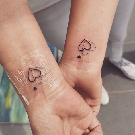 We found the coolest and prettiest matching mother-daughter tattoo ideas for 2020, ahead, including tiny stars, watercolor birds, locks and keys, and more. Matching Tattoos For Mom And Daughter Small, Tattoos For Moms Of Two, Matching Tattoos Godmother And Goddaughter, Mini Mother Daughter Tattoos, Matching Tattoos With Stepmom, Tattoos For 3 Daughters, Matching Heart Tattoos Mother Daughters, Delicate Mother Daughter Tattoos, Tiny Matching Tattoos Mother Daughter