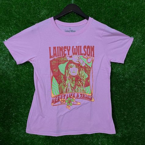 Lainey Wilson Rock T-Shirt By Ripple Junction In Pink, Size Medium. Measures 18 Inches Pit To Pit, Length 24 Inches. Ripple Junction Brand Pink Color Medium Size 18 Inches Pit To Pit 24 Inches Length Lainey Wilson Design Soft Fabric Comfortable Fit High-Quality Print Machine Washable Size: Womens Medium Condition: New Without Tags Rock Tshirt, Lainey Wilson, Rock T Shirt, Rock T Shirts, Singers, Soft Fabric, Medium Size, Pink Color, Soft Fabrics