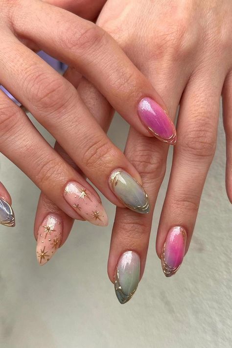 These almond-shaped nails boast a dreamy aesthetic. Featuring an iridescent finish that shimmers with a pearly luster, some nails are kissed with a delicate gradient of pink to lilac. Other nails are embellished with tiny golden stars scattered across a soft pink base, adding a touch of whimsical elegance. The look is perfectly sealed with a chic, gold-tipped outline, exuding an ethereal charm. Simply enchanting! ✨  // Photo Credit: Instagram @gloss.cee.nails Tiny Nails Ideas, Fairytale Nail Art, Whimsical Nail Designs, Ethereal Nail Design, Iridescent Butterfly Nails, Ethereal Nail Art, Pink And Golden Nails, Cute Funky Nails Almond, Aura Nails With Stars