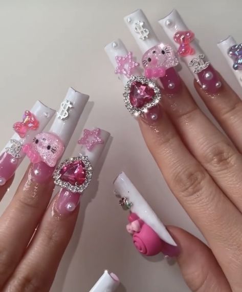 long french tip acrylic nails with pink clear base and nail accessories such as pearls, pink heart with diamonds around, hello kitty head, teaddy dears pink and purple, and pink stars. Hello Kitty Diamond, Kitty Nails, Grunge Nails, Cute Acrylic Nail Designs, Dope Nail Designs, Hello Kitty Nails, Really Cute Nails, Unique Acrylic Nails, Soft Nails