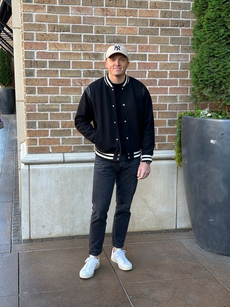 I love this simple black outfit with some pops of tan. The Veja sneakers tie in perfectly with the tan on the hat. The sweater layered with the varsity jacket was perfect for a chilly fall day. Fall Outfit Men, Simple Black Outfits, Varsity Jacket Outfit, Simple Fall Outfits, Veja Sneakers, Fall Outfits Men, Sweater Layering, Jacket Outfit, Fall Day