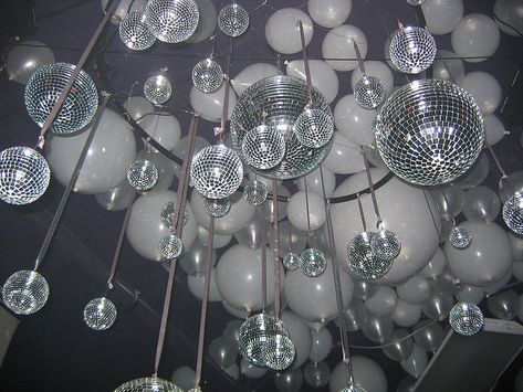 Shiny disco balls and glitter balloons- huge impact for little to no cost.  We could rent the disco balls. Balloons Ceiling, Soul Train Party, Disco Theme Party, 70s Party Theme, Studio 54 Party, 70s Theme Party, 70s Disco Party, Balloon Ceiling, Disco Birthday Party