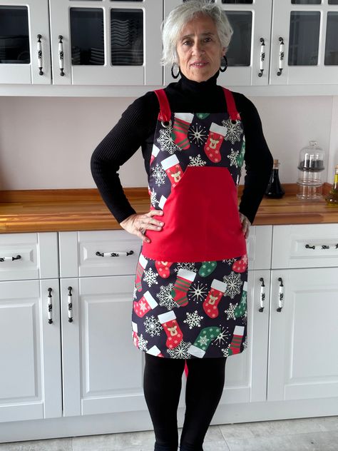 Introducing our exclusive New Year's themed apron, meticulously designed and sewn for your kitchens. The fabric showcases a festive pattern against a sophisticated black background. Combined with vibrant red plain linen, this apron is a stylish addition to your culinary space. The thoughtful design includes large kangaroo pockets for convenient storage and easy-to-use back straps for a comfortable fit. With water-repellent and stain-resistant properties, this apron is both functional and fashion Workshop Apron, Men Kitchen, Traditional Aprons, Kitchen Workshop, Apron For Men, Aprons For Women, Custom Apron, Cross Back Apron, Black Apron