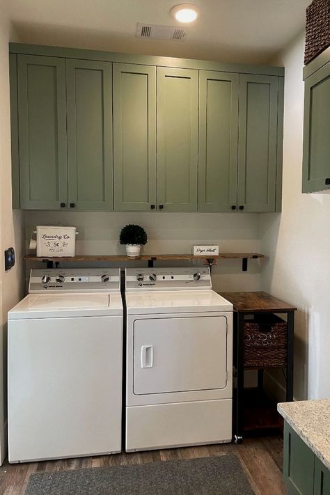 Washer And Dryer With Cabinets Above, Bathroom/laundry Room Paint Colors, Laundry Room Above Cabinet Storage, Farmhouse Laundry Room Green Cabinets, Wall Cabinets For Laundry Room, Above Washer Cabinets, Green And Gray Laundry Room, Laundry Room Cabinets Above Washer Dryer, Cabinets Above Laundry Washer And Dryer