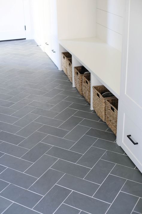 White Farmhouse Mudroom - SBK Living Farmhouse Mud Room Flooring, Farmhouse Sink Black, White Mudroom, Modern Farmhouse Mudroom, Mudroom Remodel, Farmhouse Mudroom, Laundry Room Tile, Herringbone Tile Floors, Entryway Tile