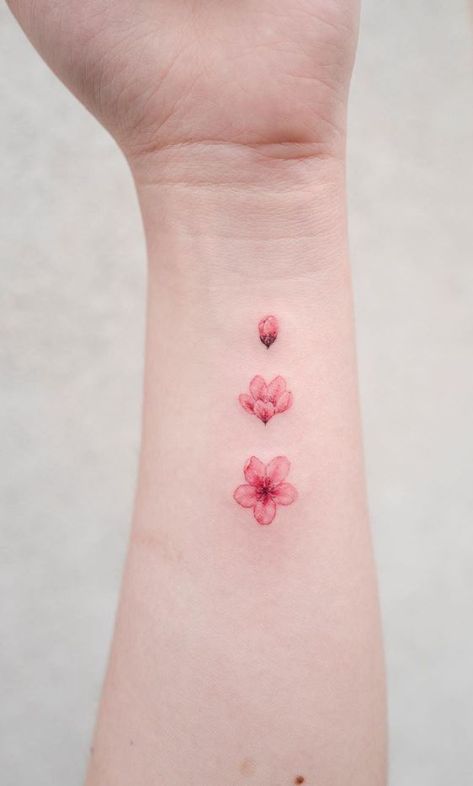 Pink Tattoo Aesthetic Small, Sakura Petal Tattoo, Cute Tattoos Red Ink, Sakura Small Tattoo, Pink Small Tattoos, Pink Color Tattoo, Blossoming Flower Tattoo, Pink Flower Tattoo Small, Small Pink Tattoo